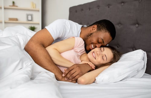 Couple cuddling after having sex