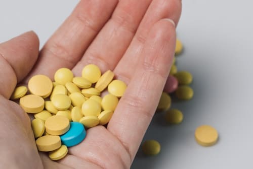 Close up of hand holding different tablets