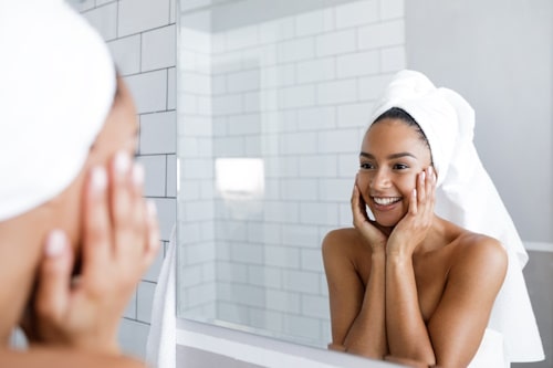 Woman happy with her skin after clay mask