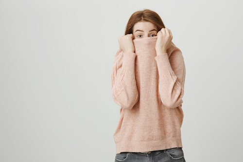 Young woman hiding her face