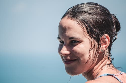 Close up of face of young woman wet with ocean water