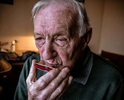 Old guy playing harmonica