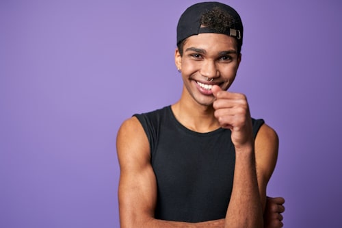 Smiling transgender man with violet background