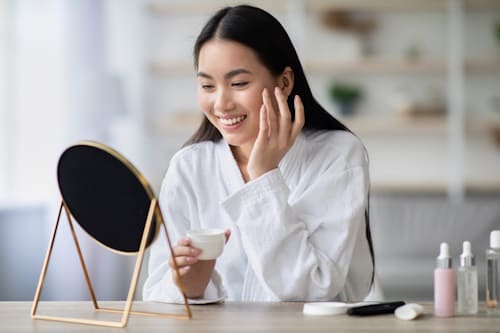 Applying face cream for skin care