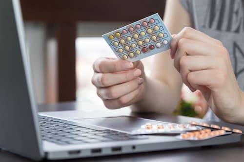 Birth Control Pills held by young woman
