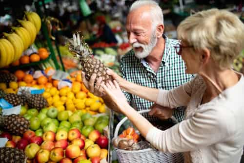 Senior couple buying healthful foods and fruits