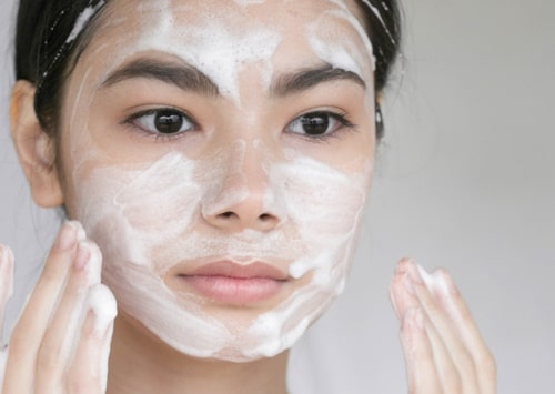 Soap face young beautiful woman washing her face