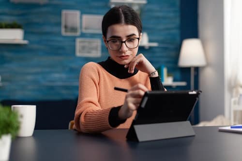 Young woman working with glasses on