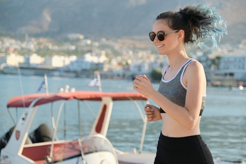 Femal teen jogging near a harbor 