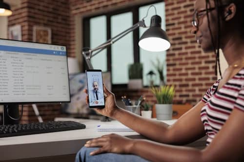 Young girl talking with doctor with telemedicine app