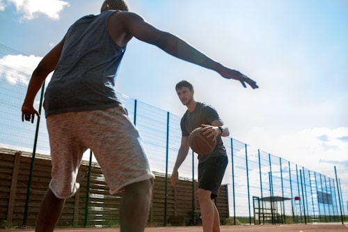 Two men playing basketball 