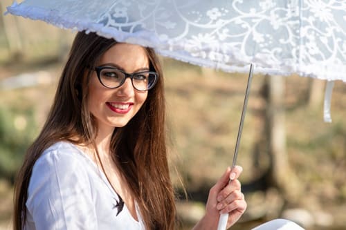 Woman using an umbrella due to sun sensitive skin