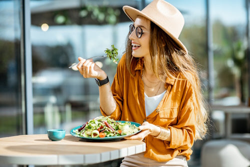 Woman eating vegetable salad