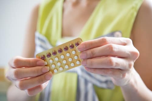Woman taking birth control pills