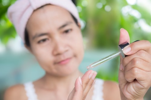 Woman dropping benzoyl peroxide for butt acne