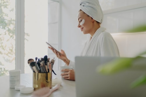 Woman waiting for vitamin c serum to be absorbed by skin