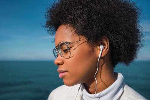 African American woman using earphones
