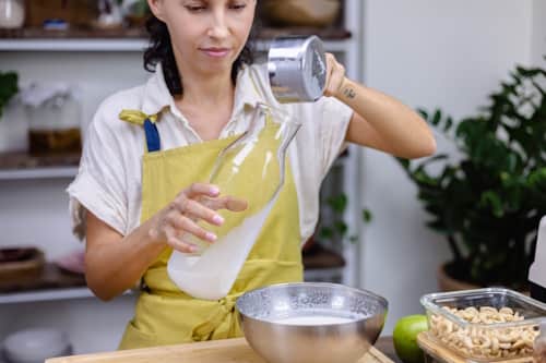 Woman making almond milk