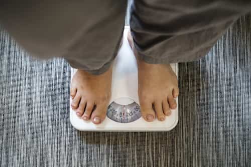 Woman standing on weighing scale