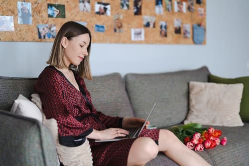 Woman using laptop at home relaxing