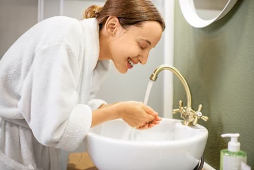 Woman washing her face