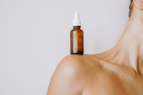 Acne serum on womans shoulders