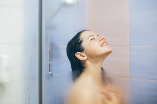 Woman taking hot steaming shower