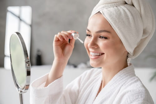 Woman applying face serum