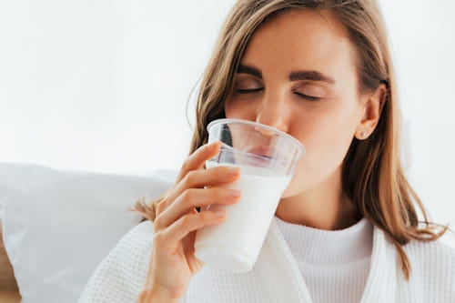 Adult woman drinking milk