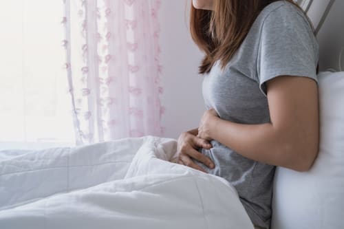 Woman suffering from symptoms of PCOS