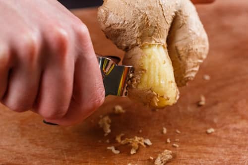 Grating ginger with kitchen tool