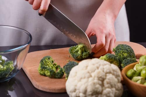 Chef cutting brocolli for cooking