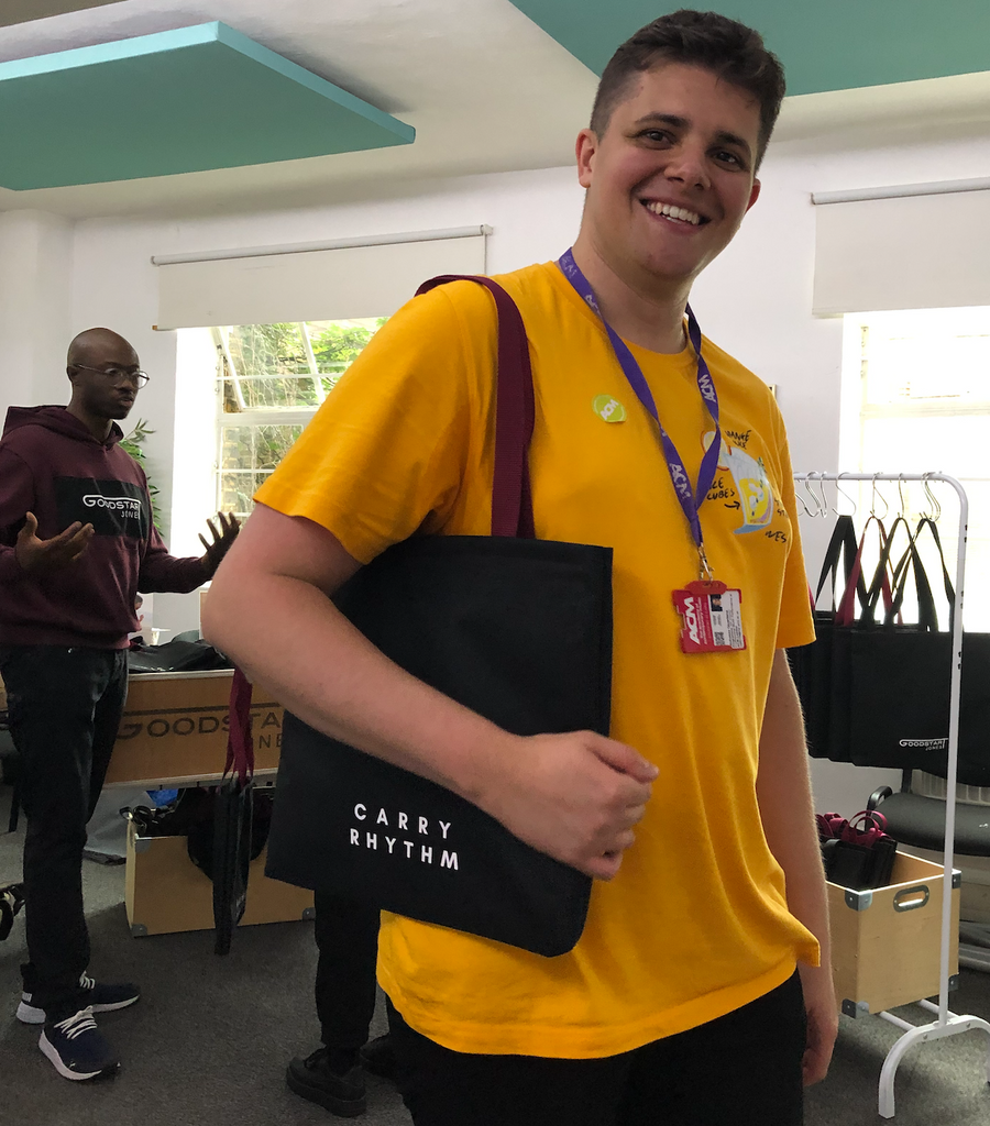 Cool Music Student holding a Goodstart Jones Tote Bag 