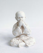 front view of speak no evil monk with button to navigate to gifting