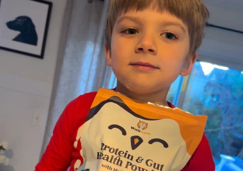 Child holding a bag of protein powder with a penguin design.