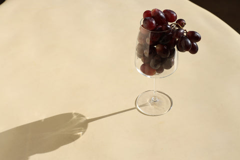 a wine glass full of grapes