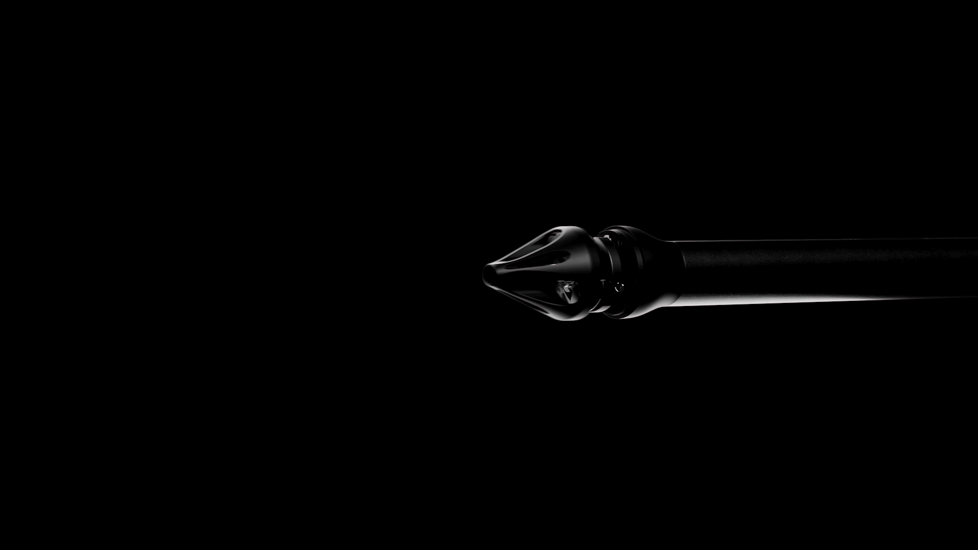 Close-up of a black tattoo machine needle on a dark background.