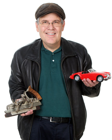 Jim Pennoyer holding a model car and an antique