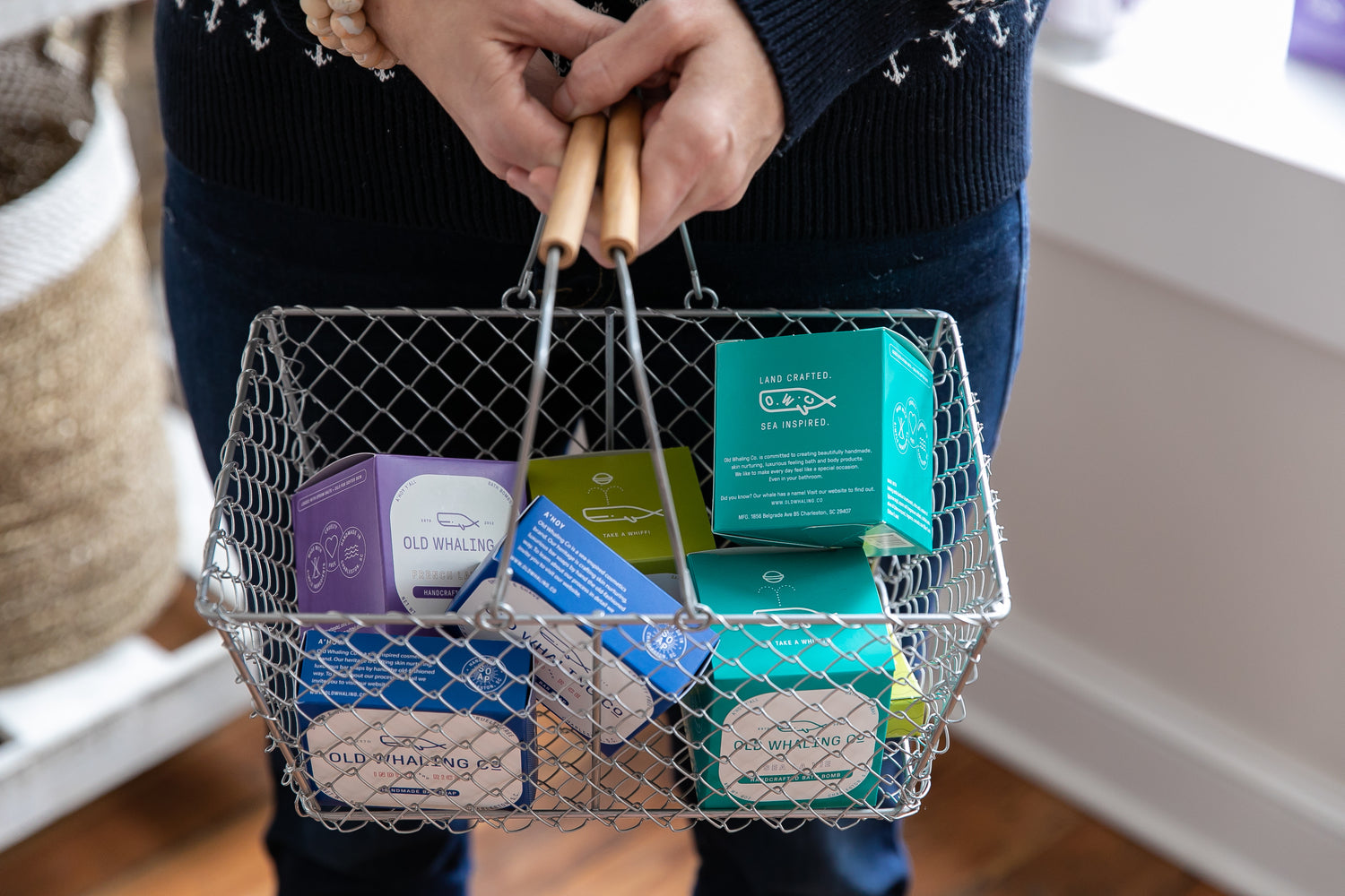 Women holding a basket of Bar Soaps and Bath Bombs