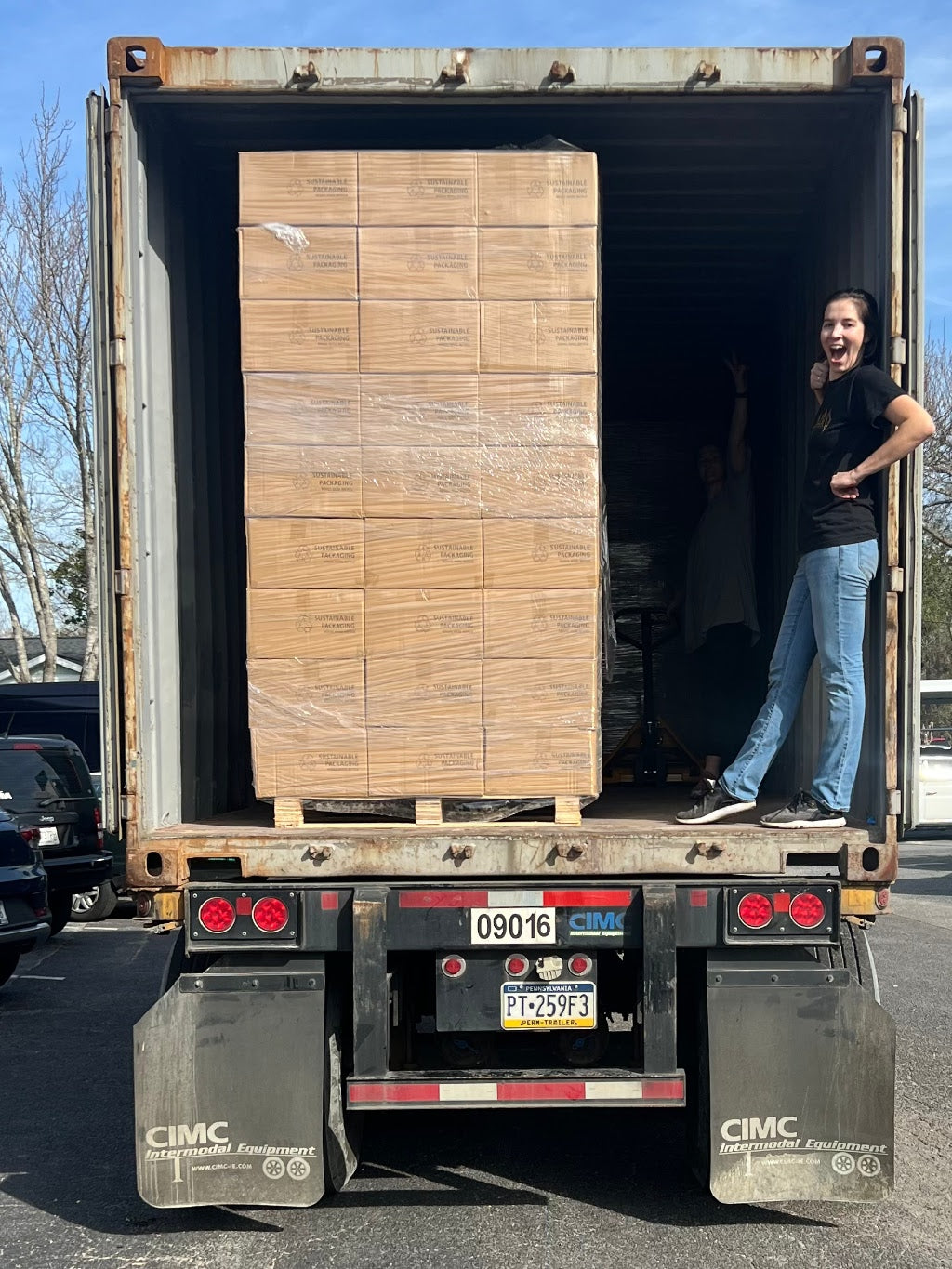 Celia, VP of Production unloading our container of custom candle jars! 