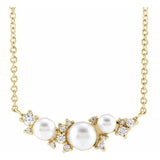 Cultured White Akoya Pearl Necklace adorned with Sparkling Diamond Accents in 14K Gold. 