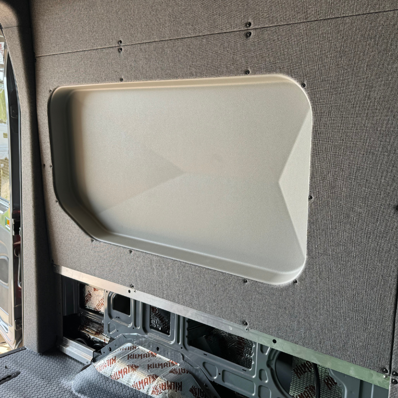 Space-saving interior van capsule enabling sideways sleeping without exterior mods