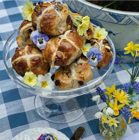 Easter Table with Hot Cross Buns and decorated with wild flowers