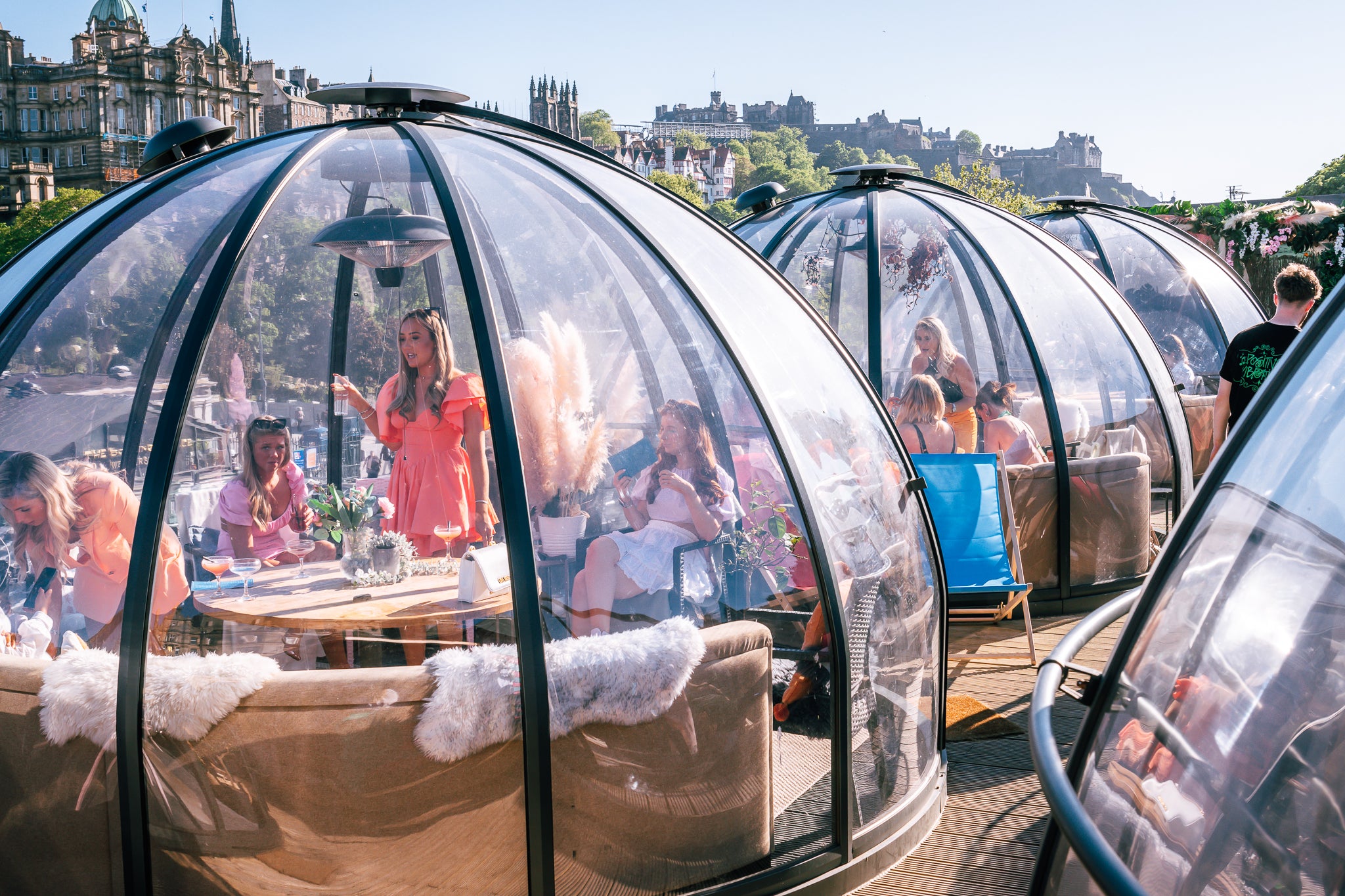 Glass domes with people inside on a sunny day