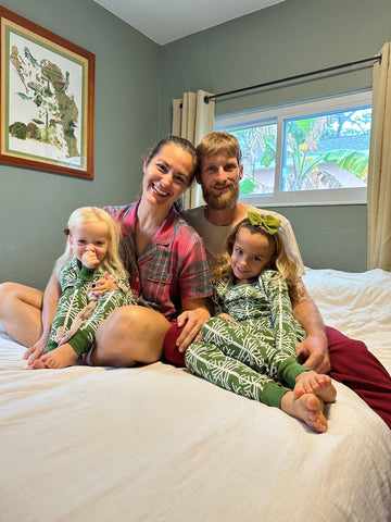 Family wearing organic cotton pajamas with holiday prints.