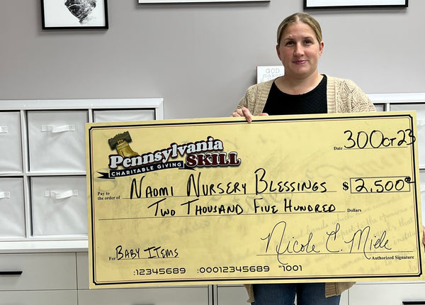 Amanda Biddle, Founder and President of Naomi Nursery Blessings, accepts a $2,500 donation on behalf of the nonprofit from Pennsylvania Skill Charitable Giving.