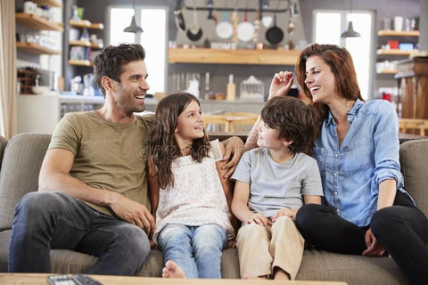 family is sitting in sofa lounge and talking together