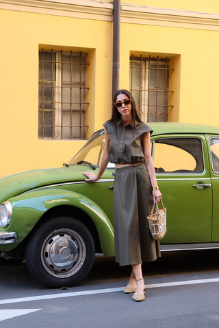 a lady in a grey elastic hem top and a grey A-line skirt