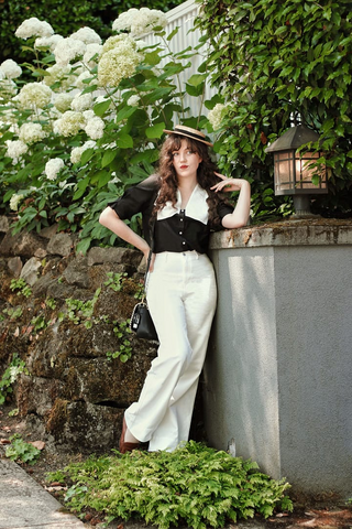 a lady in a lapel black and white T-shirt and a pair of white jeans