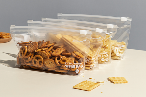 Snack bags being shown storing different sized cookies and crackers to show its size capabilities